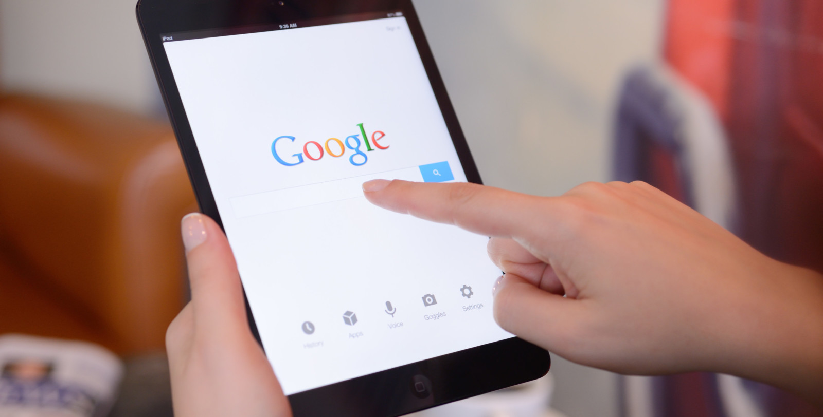 A woman begins a Google search prompting Google ads to come up