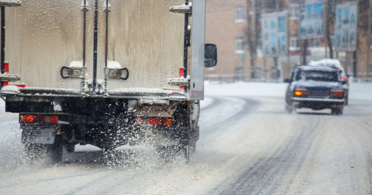 A junk removal truck carries on work during the winter months